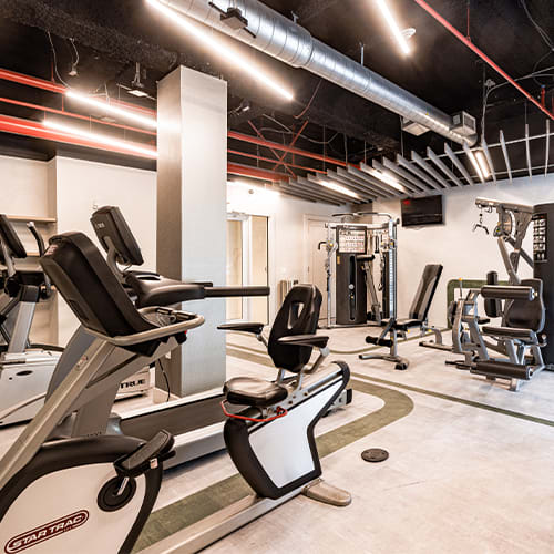 a room filled with lots of different types of exercise equipment