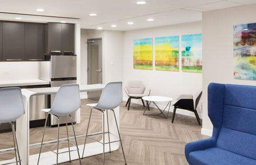Social room with kitchen, chairs, and tables