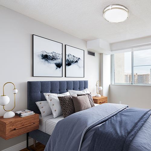 Staged bedroom with queen-sized bed and stunning city-view.