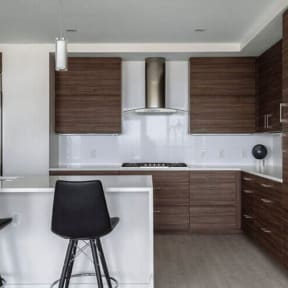 a kitchen with a white counter top and a black chair at Altaire, Arlington, Virginia