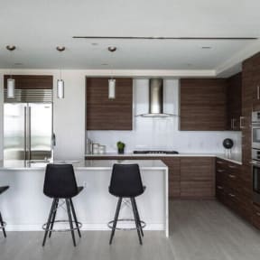 a kitchen with a white counter top and brown cabinets at Altaire, Arlington, 22202