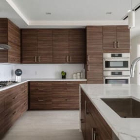 a kitchen with wooden cabinets and a white counter top at Altaire, Arlington, VA