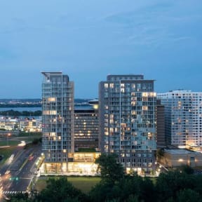 a cityscape at night with tall buildings and trees in the foreground at Altaire, Arlington, VA, 22202