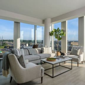 a living room filled with furniture and a large window at Altaire, Arlington, 22202