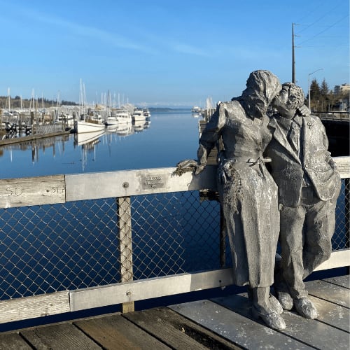 a statue of a man and woman standing on a pier at Harbor Heights 55+ Community, Olympia, 98501