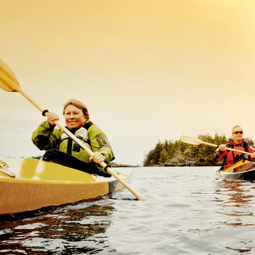 a woman and a man in a kayak on a lake at Harbor Heights 55+ Community, Olympia, 98501