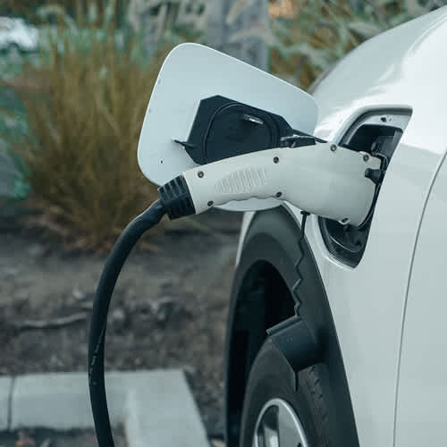 An electric car is plugged into a charging station.