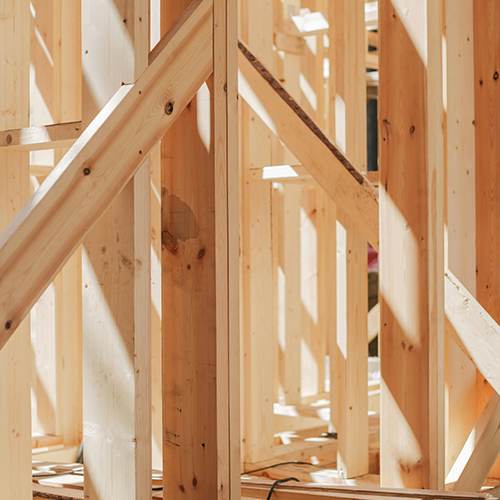 A wooden frame structure of a building under construction.