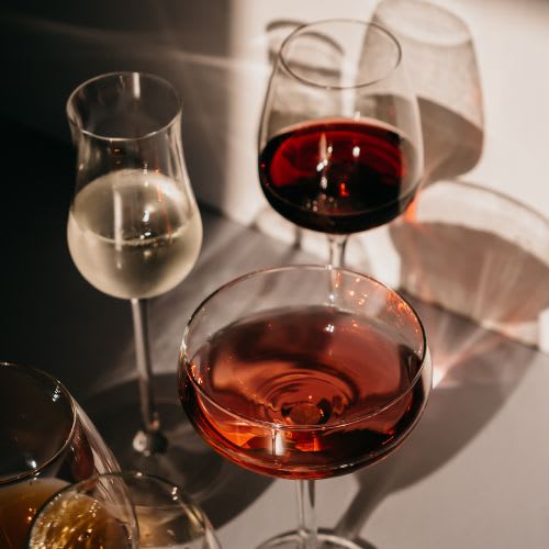 A glass of white wine is on the table.