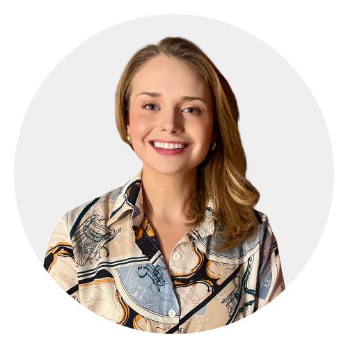 A woman with blonde hair wearing a patterned shirt.