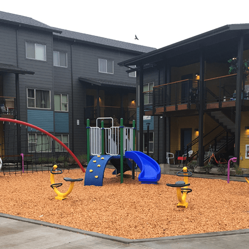 a playground in the courtyard of a apartment building