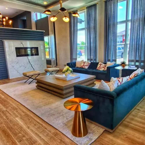 A modern living room with a dark blue sofa and a coffee table.