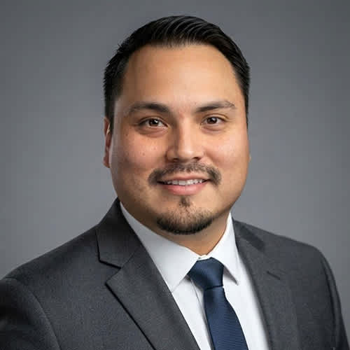 A man with a beard and mustache wearing a suit and tie.