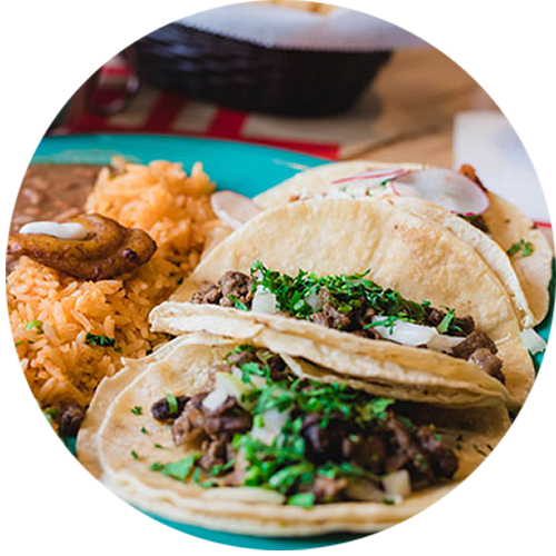 a plate of tacos and rice on a table