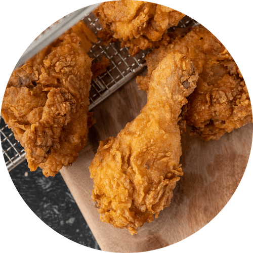 a plate of fried chicken on a wooden board