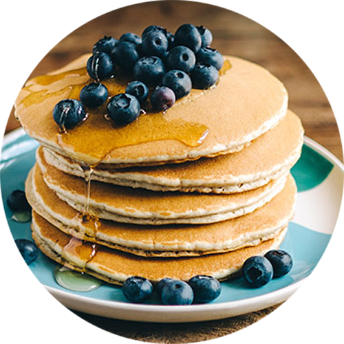 a stack of pancakes with blueberries on top
