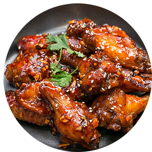 a plate of chicken wings covered in teriyaki sauce