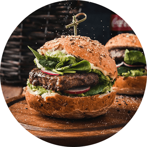 A close-up of a burger with a toothpick in it.