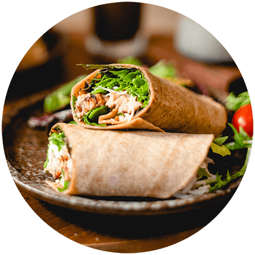 a sandwich on a plate with a salad
