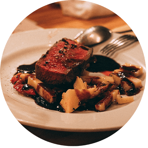 a plate of food with a piece of steak and vegetables