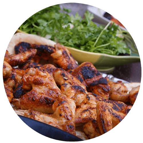 a plate of chicken and a bowl of greens