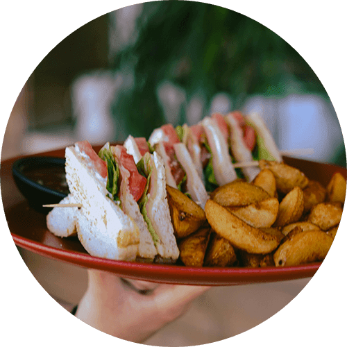 A plate of food with sandwiches and fries.