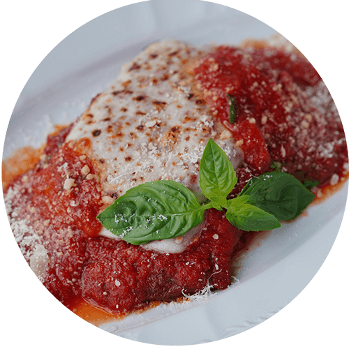 A plate of food with a red sauce and a green leafy garnish.