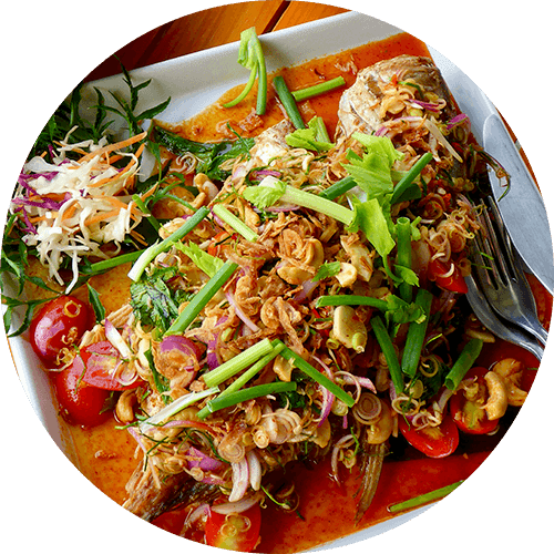 A plate of food with a piece of meat and vegetables.
