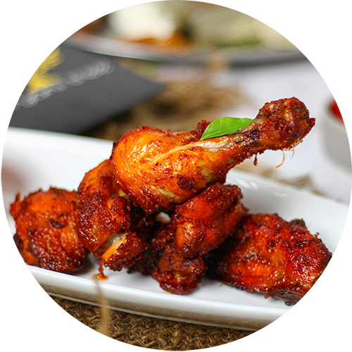 a plate of chicken wings with sauce on a table