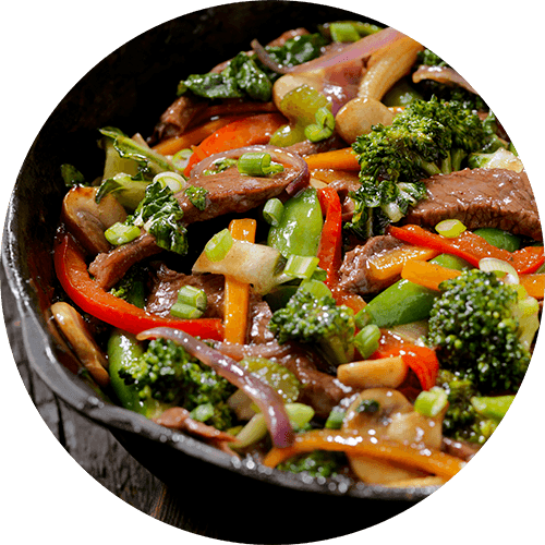 A plate of food with a piece of meat and vegetables.