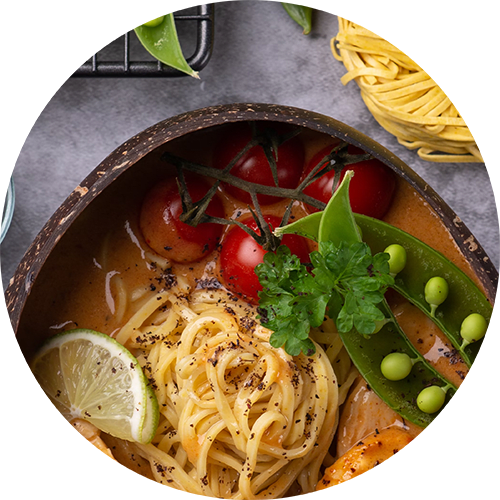 a bowl of pasta with tomatoes and olives and herbs
