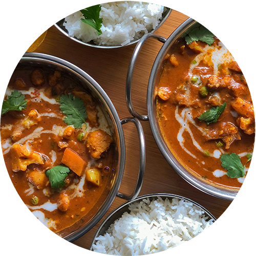 a table topped with bowls of curry and rice