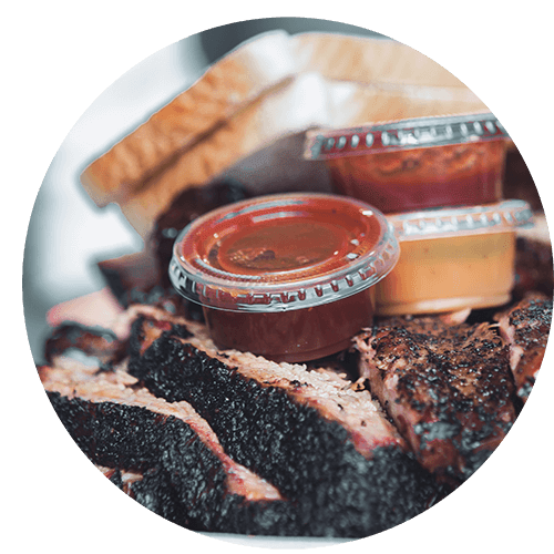 a plate of food with barbecue sauce and ribs