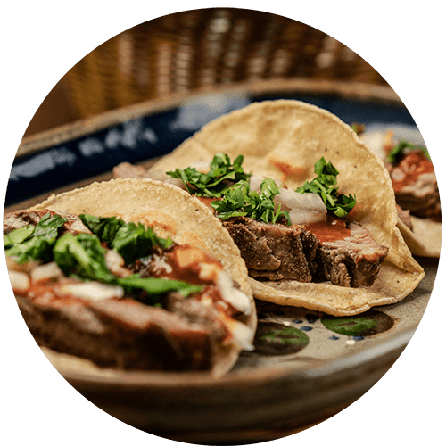 three tacos on a plate on a table