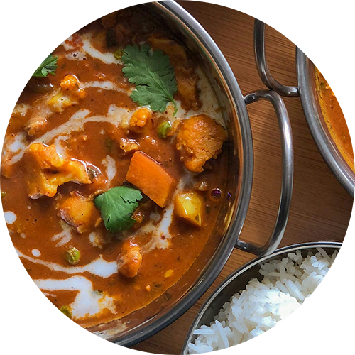 a pot of curry and rice on a table