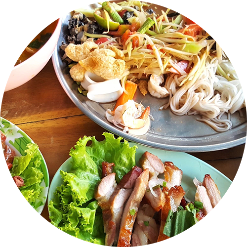a plate of food and a bowl of salad on a table