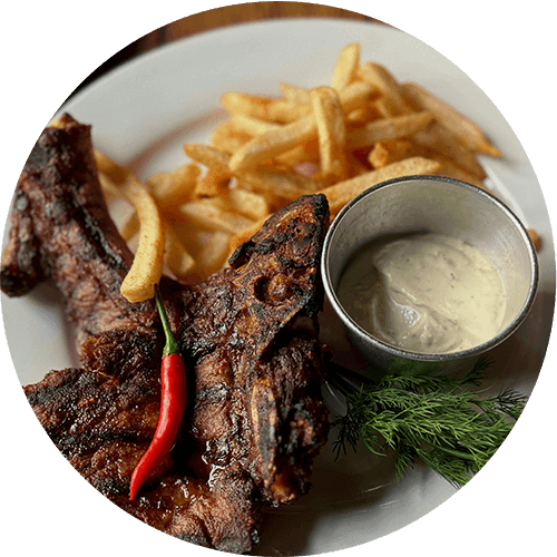 a plate of steak fries and a dipping sauce