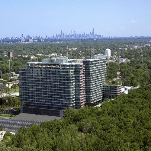 a tall building with a city skyline in the background