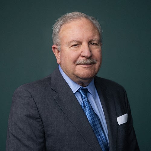 a man in a white shirt posing for a picture