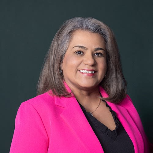 a woman in a pink jacket and a black shirt