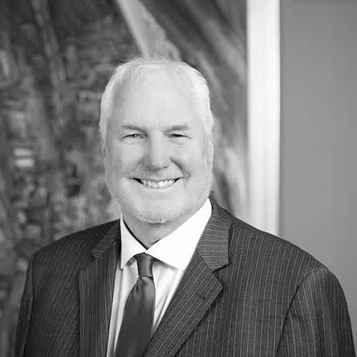 a man in a suit and tie smiles at the camera