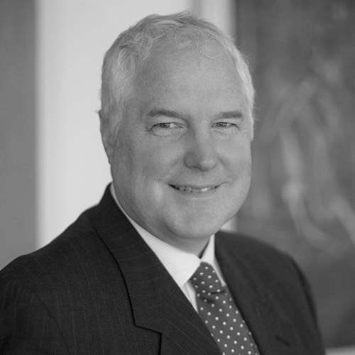 a man in a suit and tie smiles at the camera