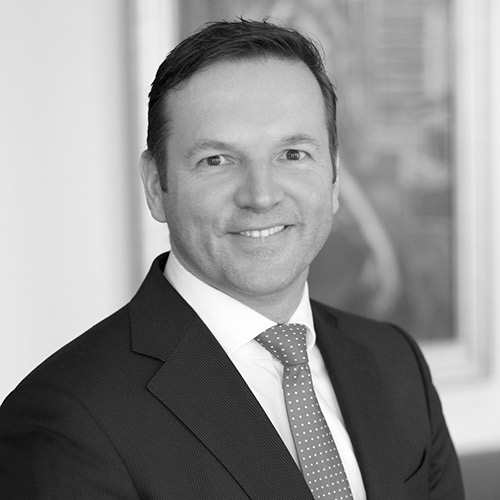 a man in a suit and tie smiling