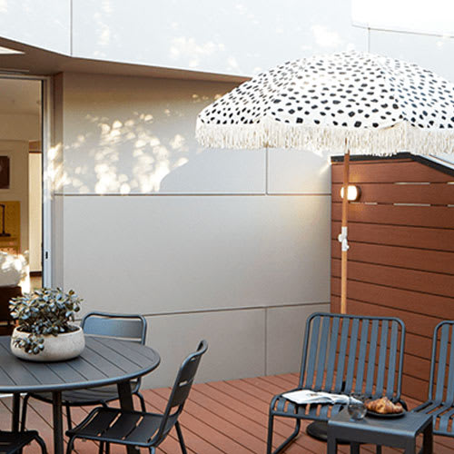 a patio with a table and chairs and an umbrella