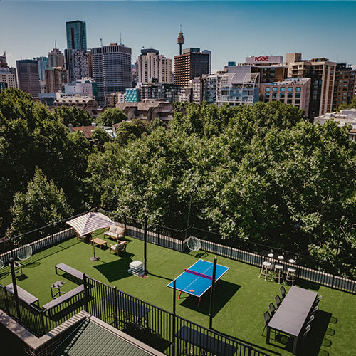 a backyard with a tennis court and a city skyline