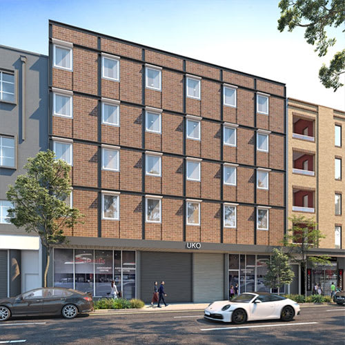 a rendering of a brick apartment building with cars parked in front