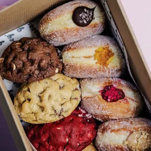 A box of assorted cookies and doughnuts.