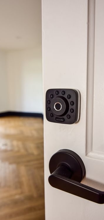 an open door with a door handle and a sensor on the door