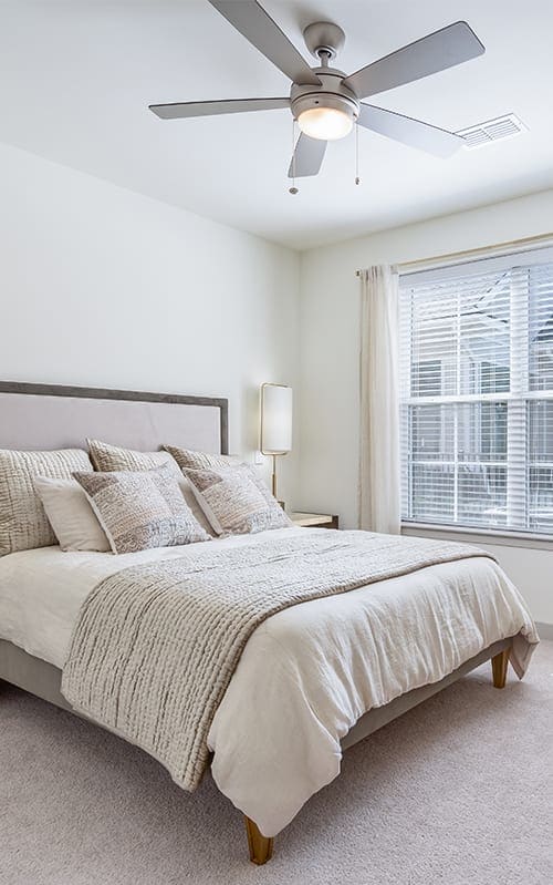 a bedroom with a bed and a ceiling fan at Canopy at Ginter Park Apartments, Richmond, VA, 23227