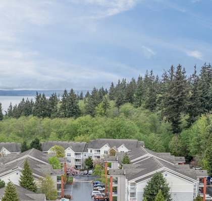 an aerial view of a parking lot with many buildings and trees